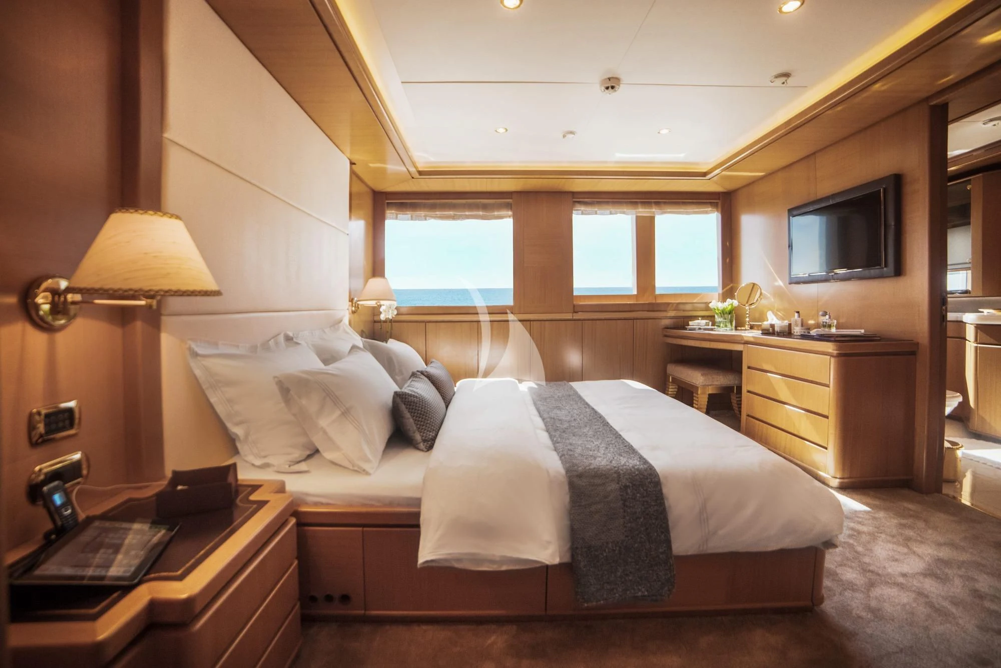 a bedroom with a bed and a desk aboard OASIS Yacht for Sale