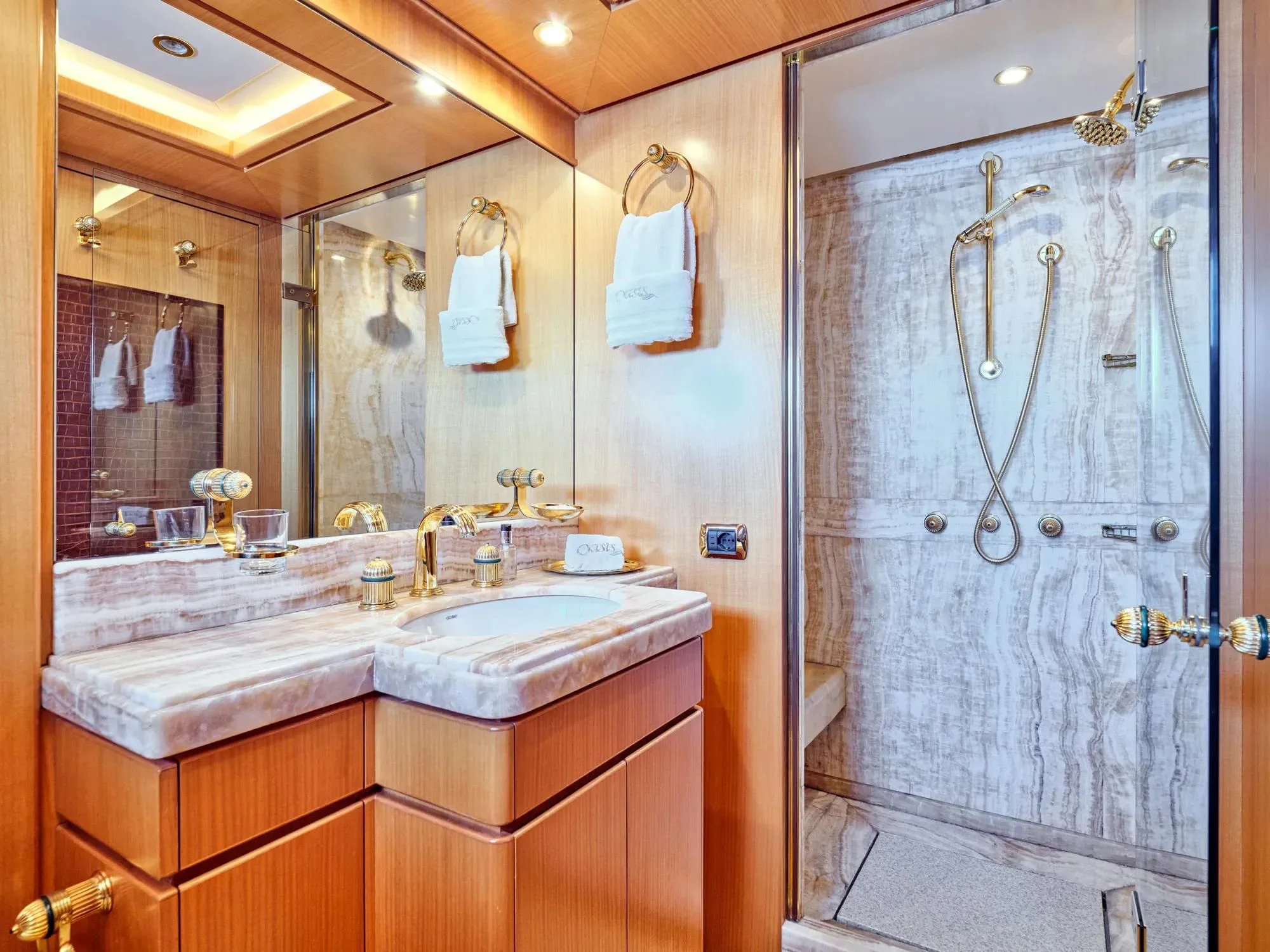 a bathroom with a large mirror aboard OASIS Yacht for Sale