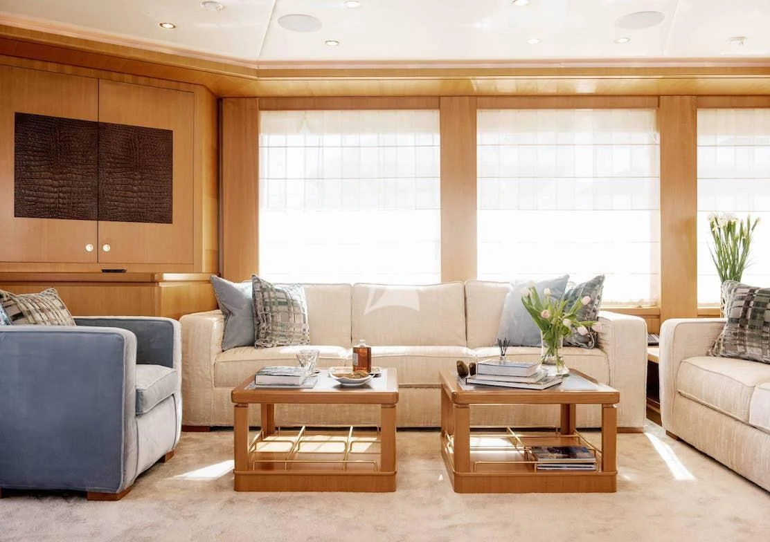 a living room with a coffee table aboard OASIS Yacht for Sale