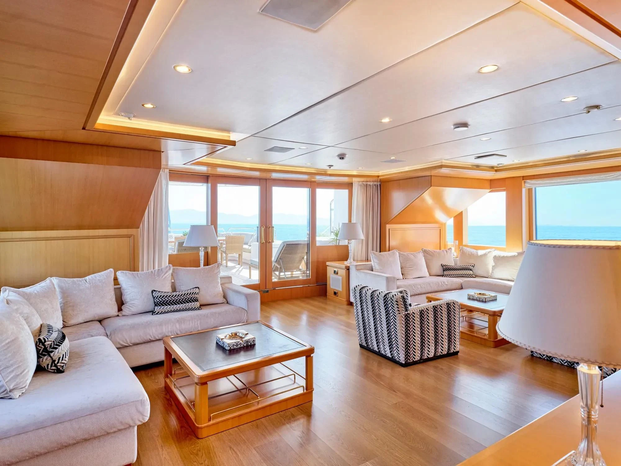 a living room with a large window aboard OASIS Yacht for Sale