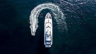 a white boat in the water aboard OASIS Yacht for Sale