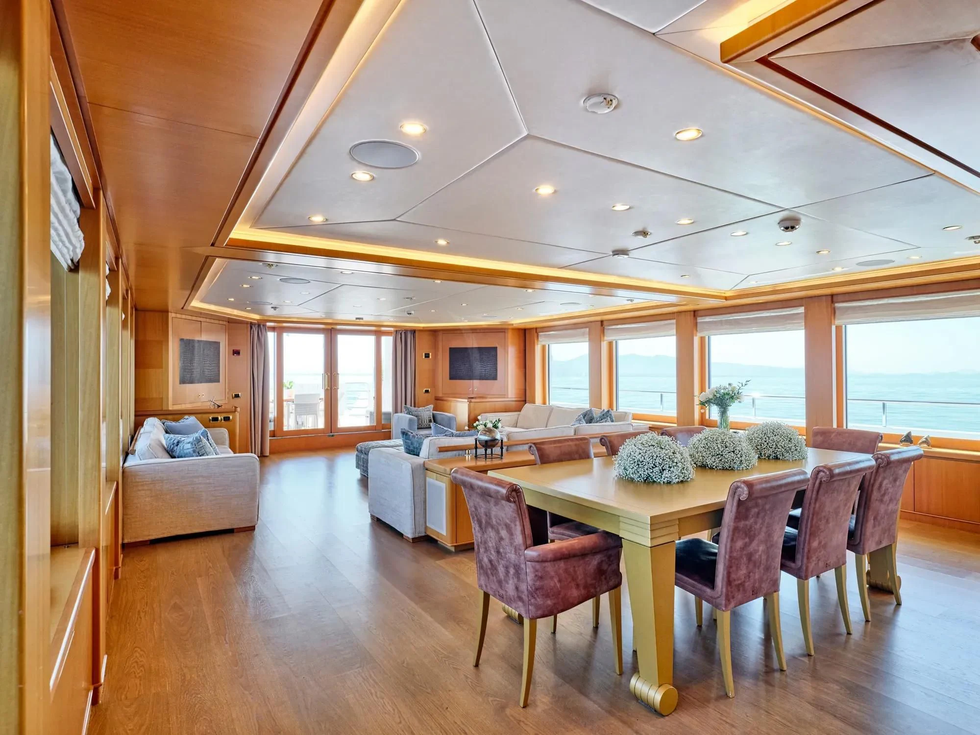 a large dining room with a table and chairs aboard OASIS Yacht for Sale