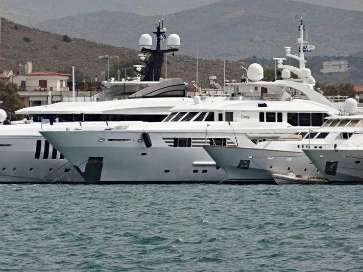 a couple of white yachts in the water aboard OASIS Yacht for Sale