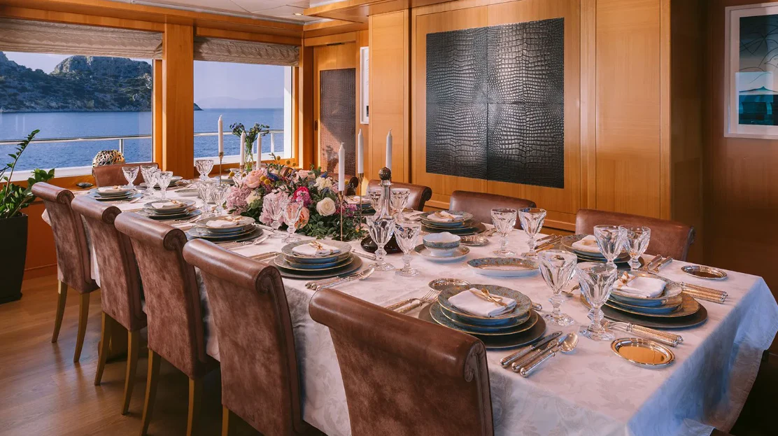 a table set for a dinner aboard OASIS Yacht for Sale