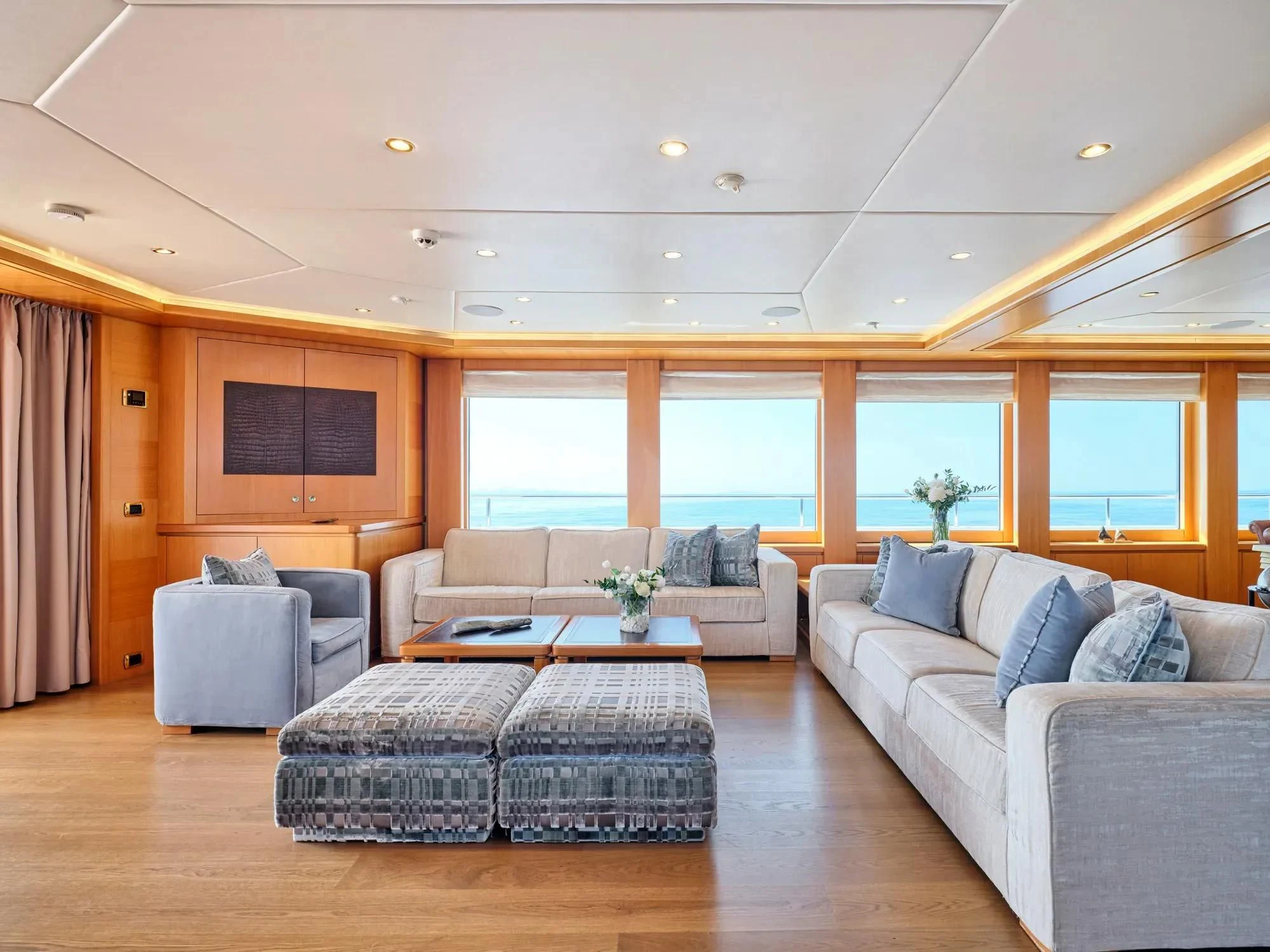 a living room with a couch and a table aboard OASIS Yacht for Sale