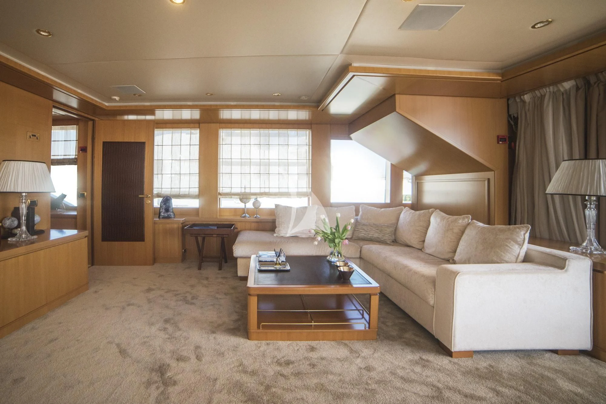 a living room with a couch and a coffee table aboard OASIS Yacht for Sale