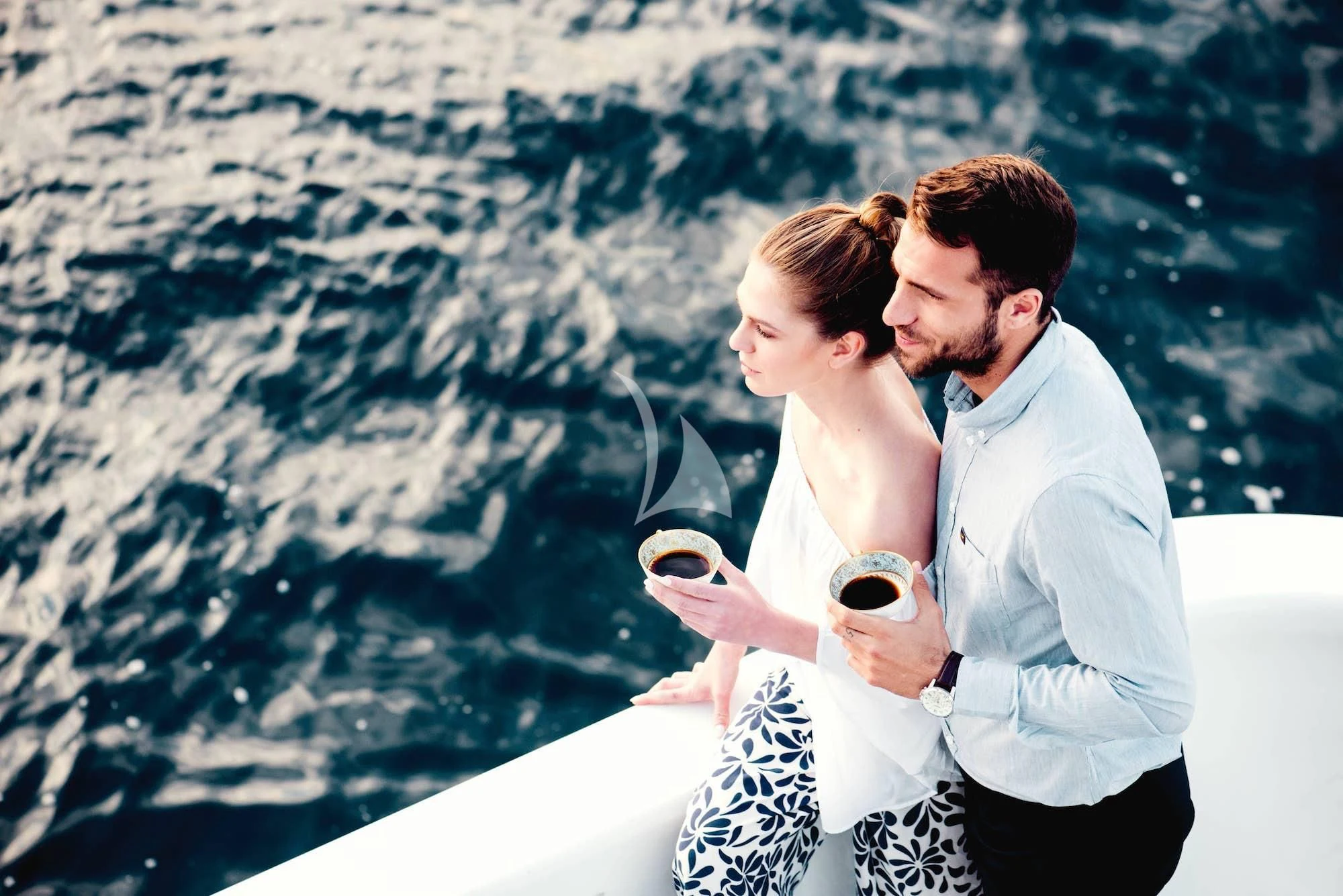 a man and woman kissing aboard OASIS Yacht for Sale