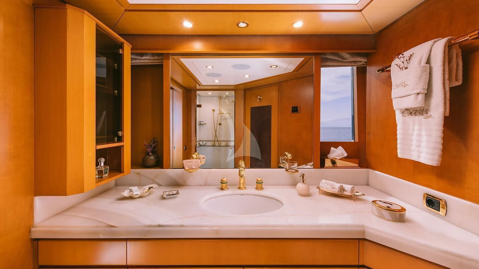 a bathroom with a large mirror aboard OASIS Yacht for Sale