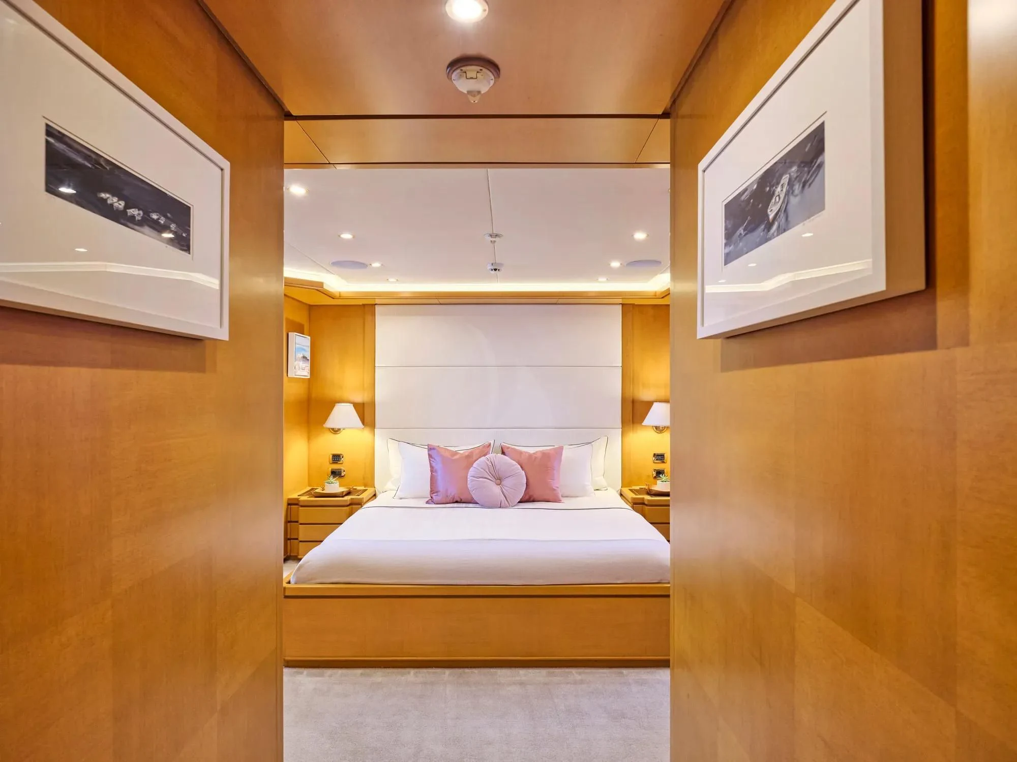 a bedroom with a bed and a lamp aboard OASIS Yacht for Sale