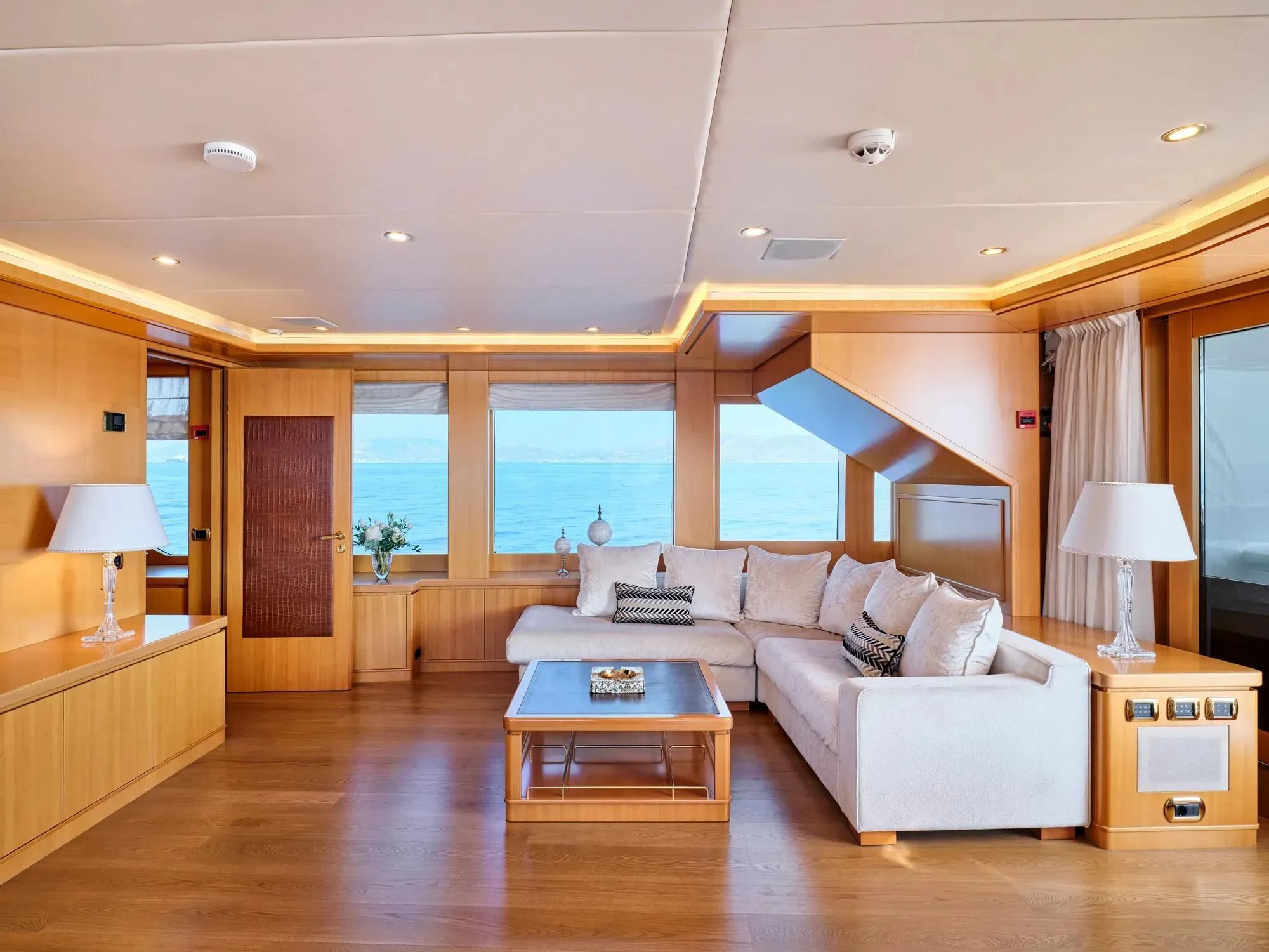 a living room with a large window aboard OASIS Yacht for Sale