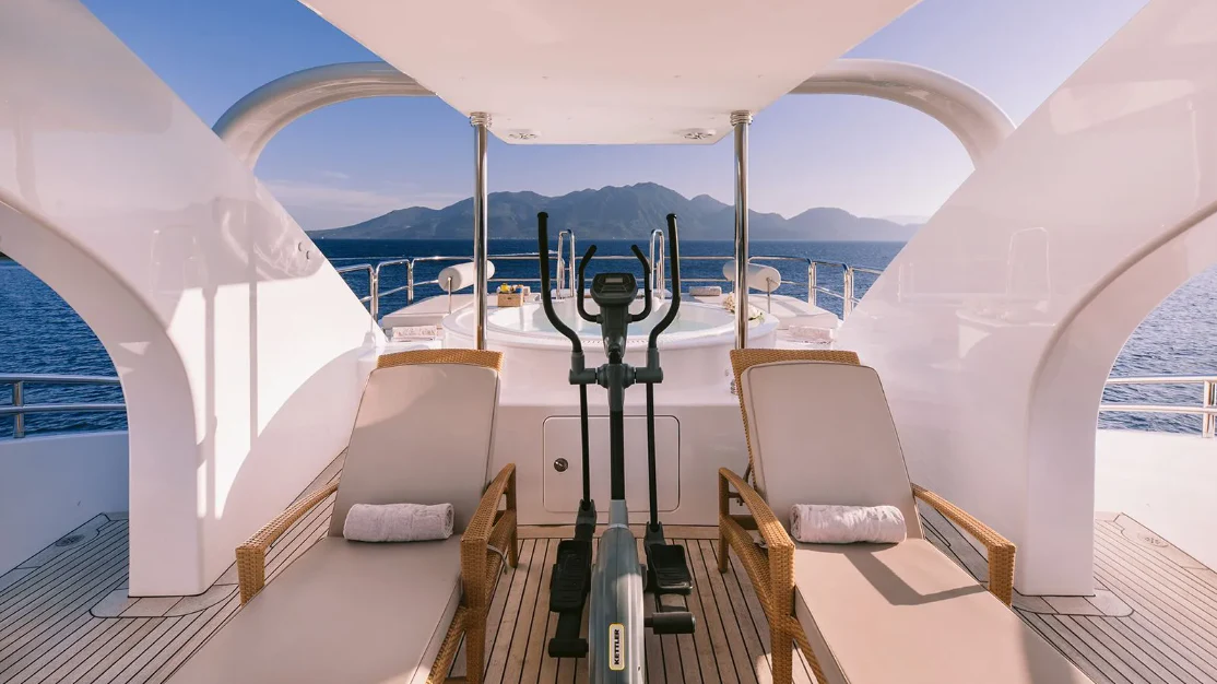 a room with a table and chairs aboard OASIS Yacht for Sale