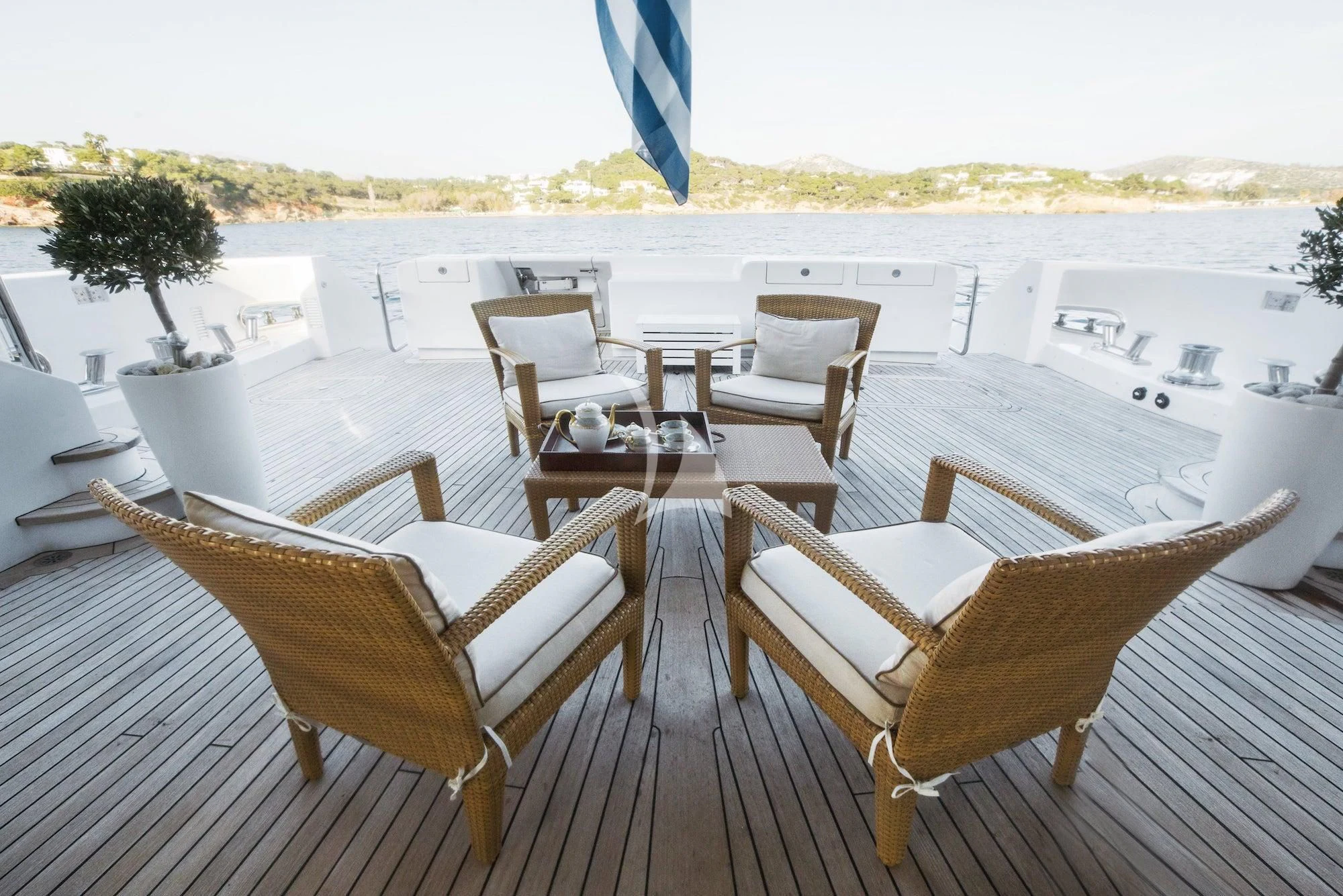 a deck with chairs and tables on it aboard OASIS Yacht for Sale