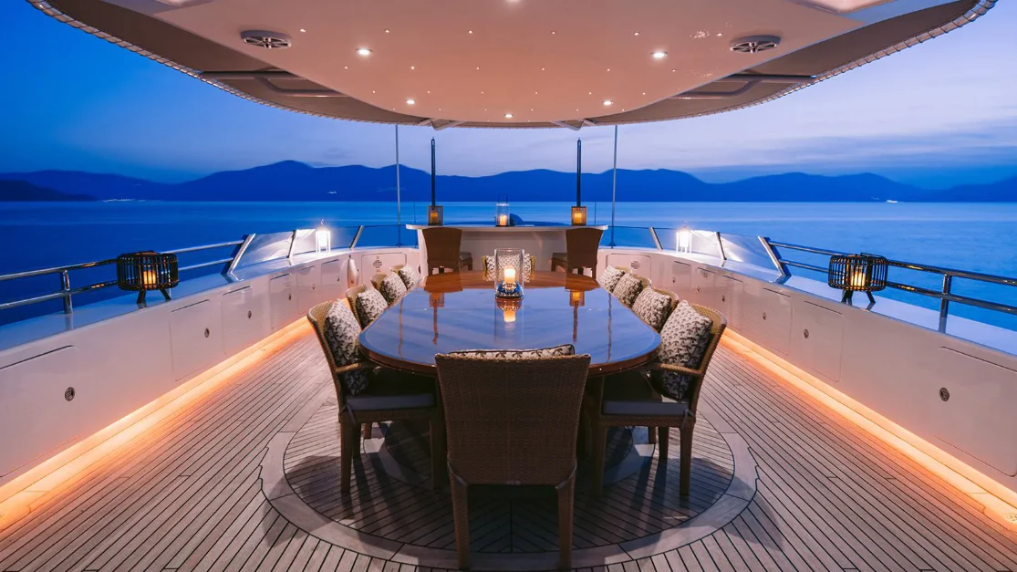 a table on a deck overlooking the ocean aboard OASIS Yacht for Sale