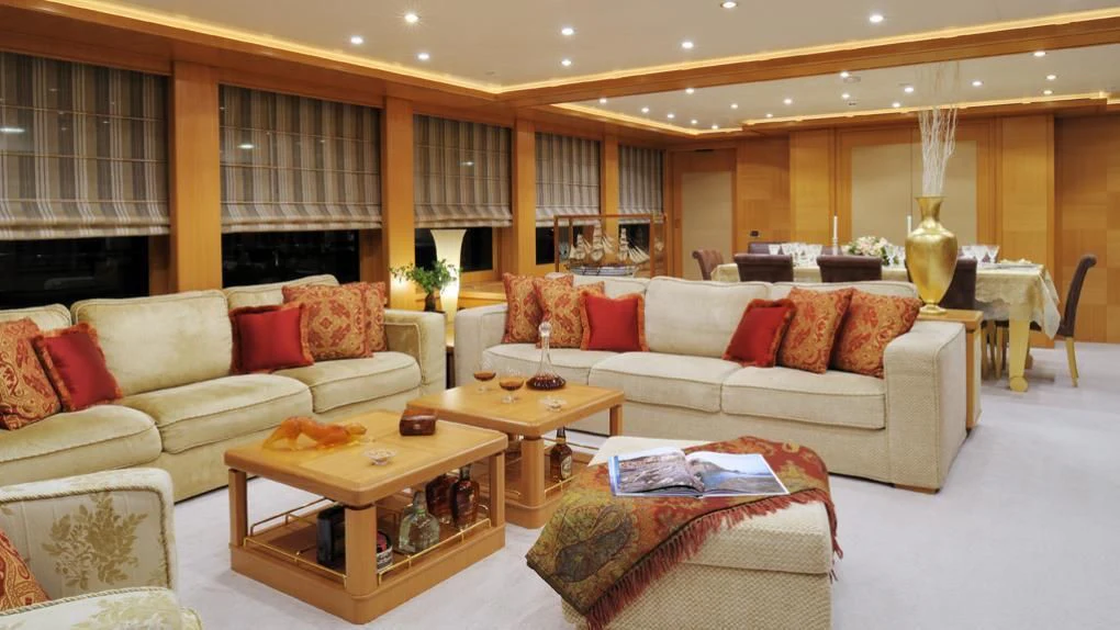 a living room with a couch and a coffee table aboard OASIS Yacht for Sale