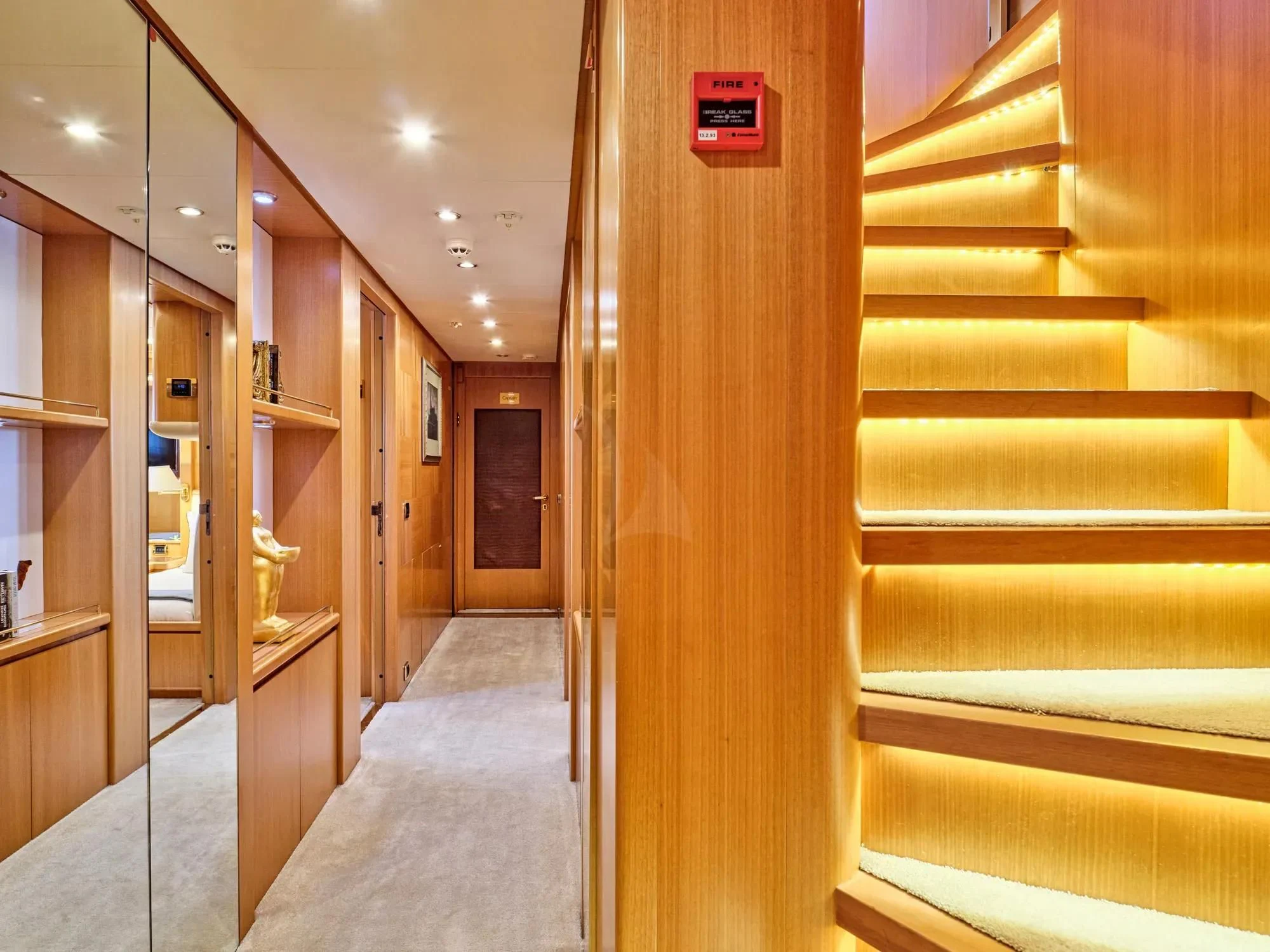 a hallway with wooden cabinets aboard OASIS Yacht for Sale