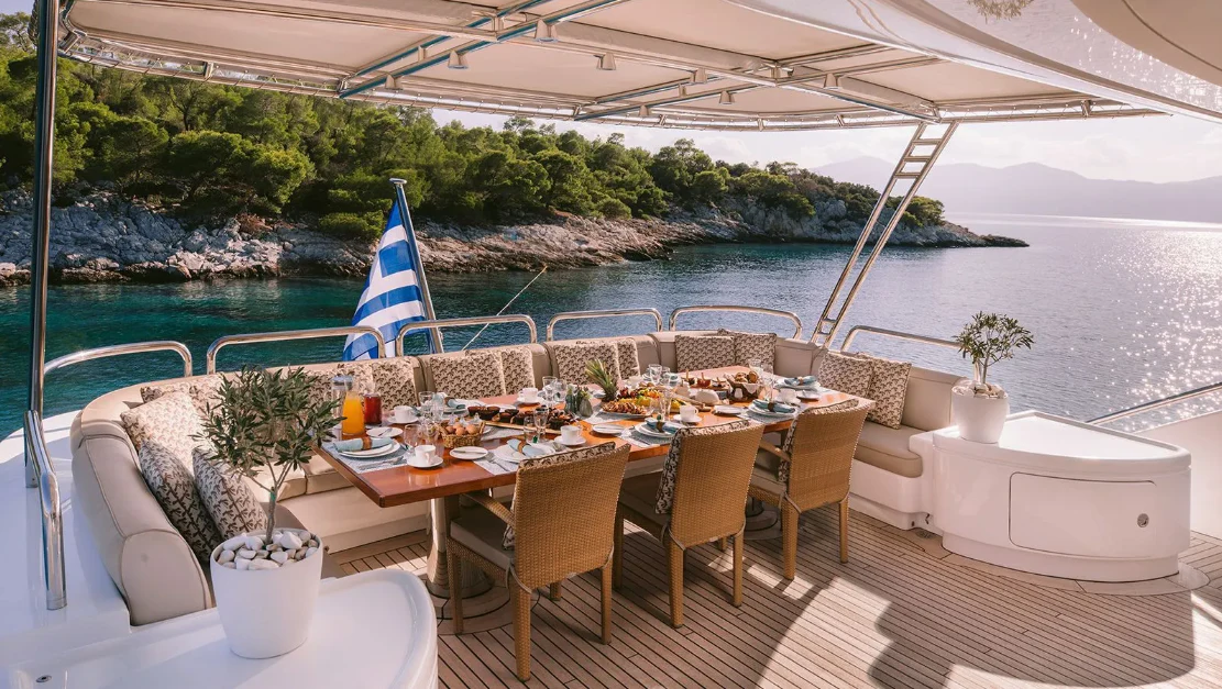 a table set for a meal on a boat aboard OASIS Yacht for Sale