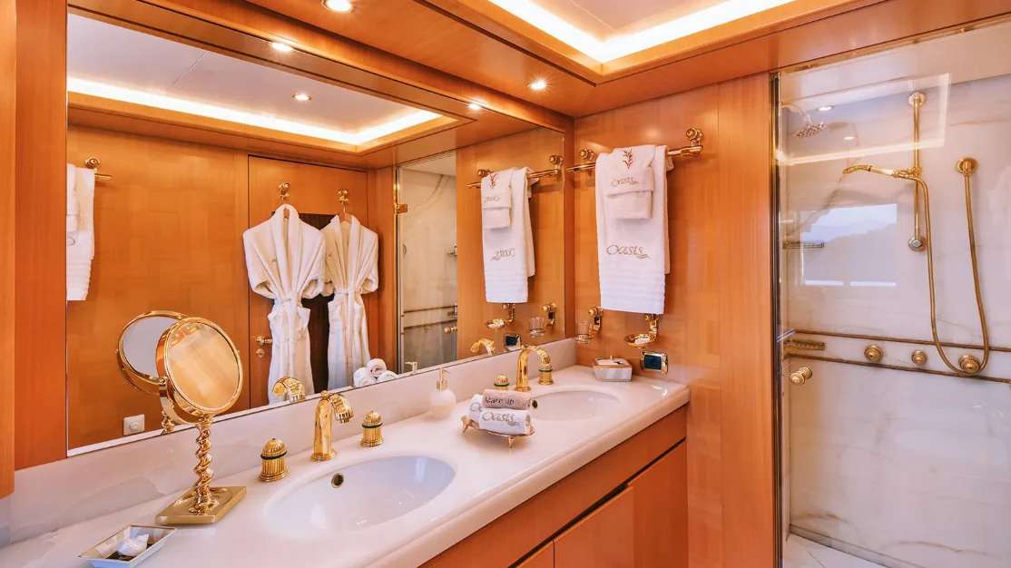 a bathroom with a large mirror aboard OASIS Yacht for Sale