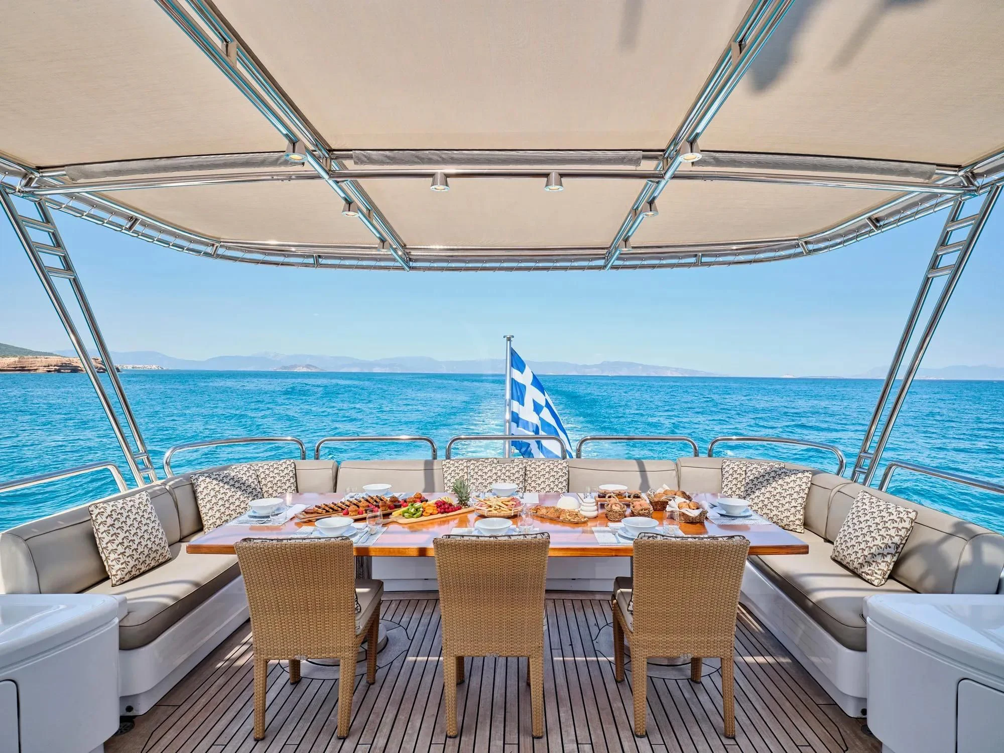a table set for a meal on a boat aboard OASIS Yacht for Sale