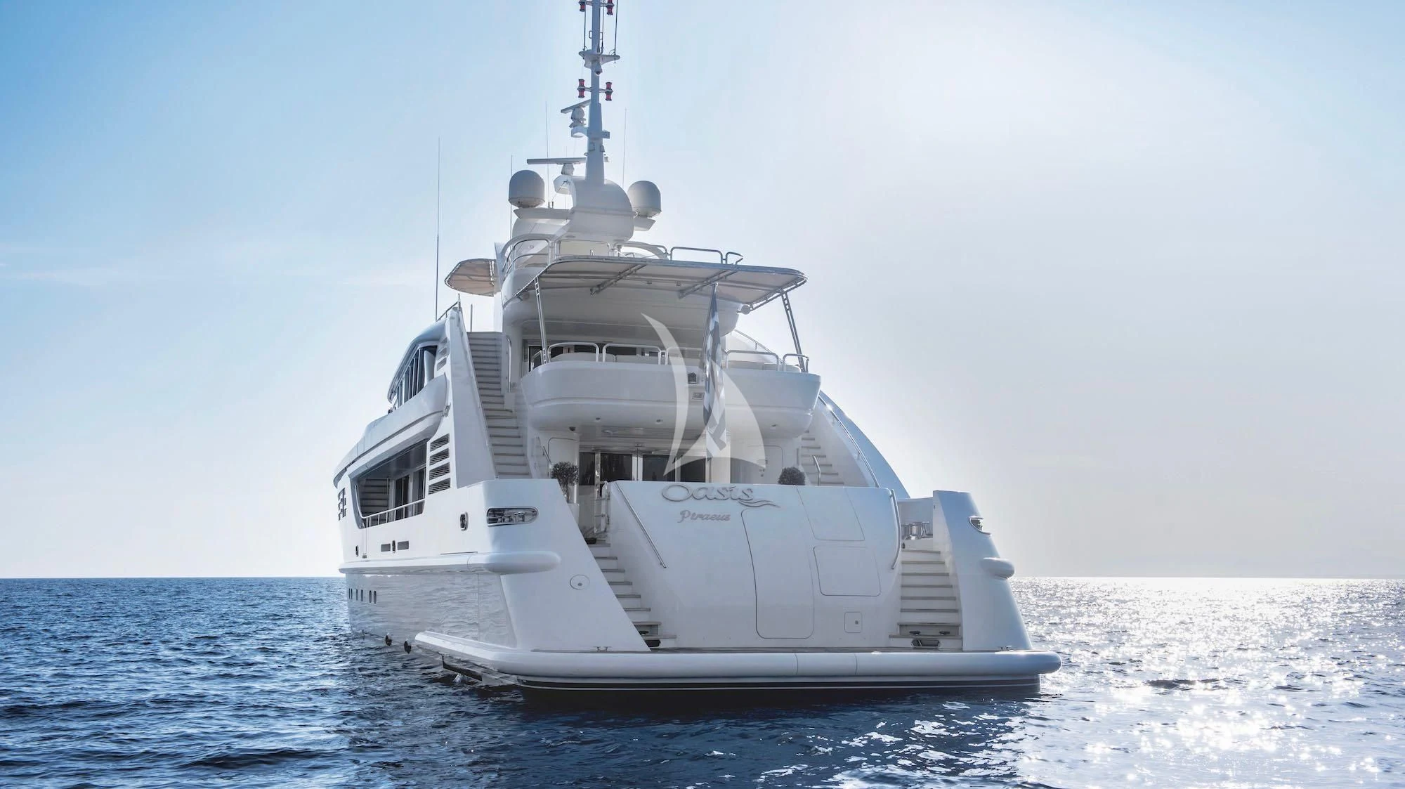 a white boat in the water aboard OASIS Yacht for Sale