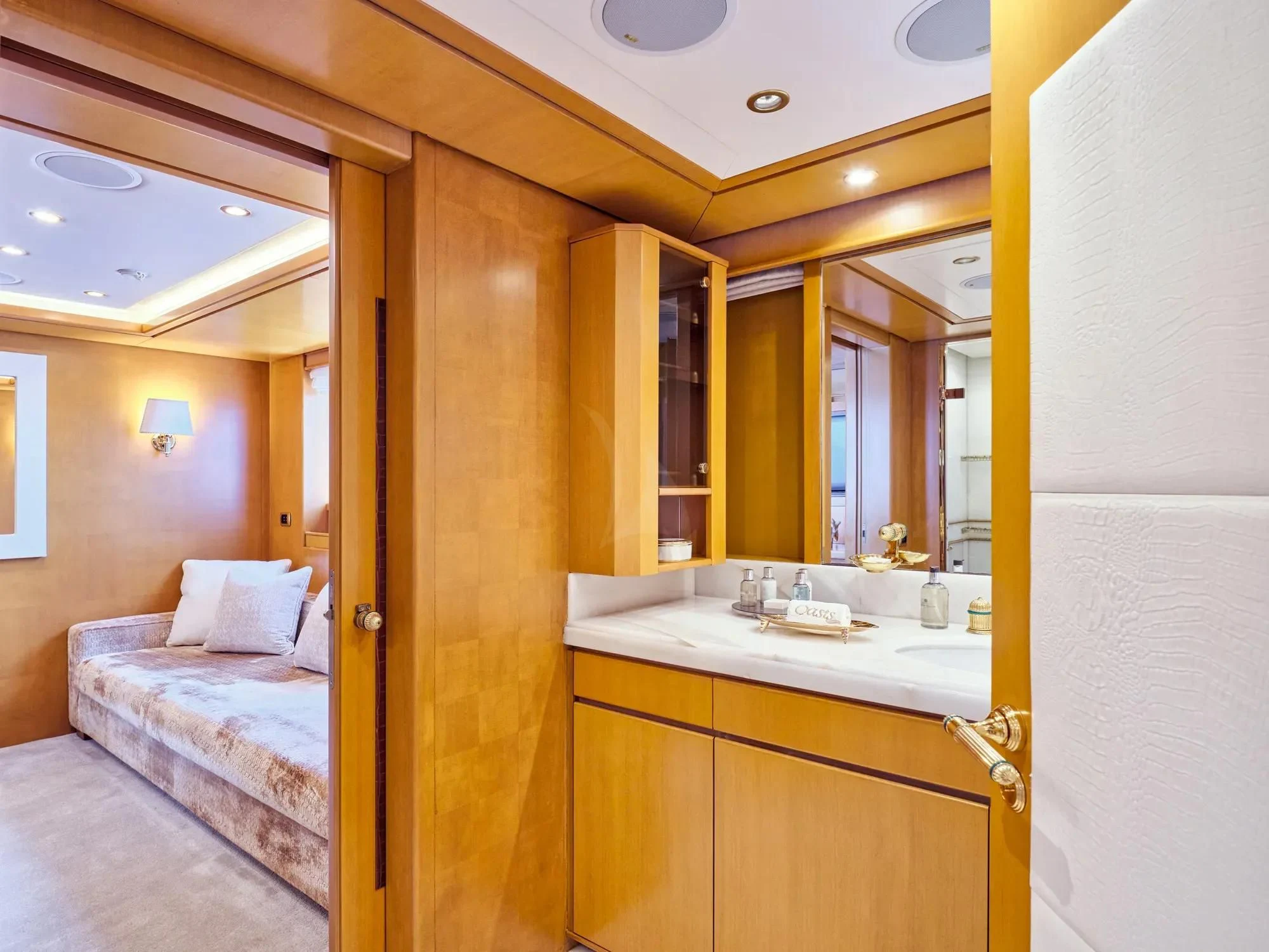a bathroom with a sink and a bed aboard OASIS Yacht for Sale