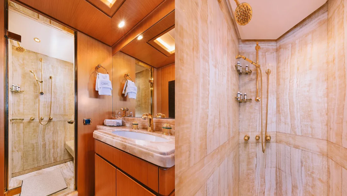 a bathroom with a shower and sink aboard OASIS Yacht for Sale