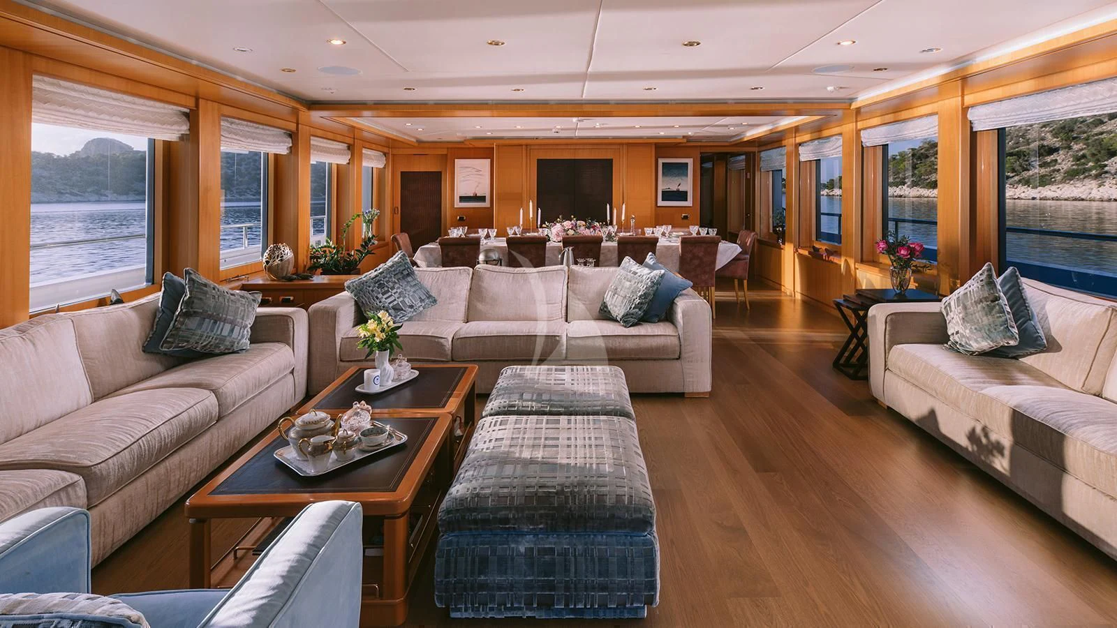 a living room with a couch and a table aboard OASIS Yacht for Sale