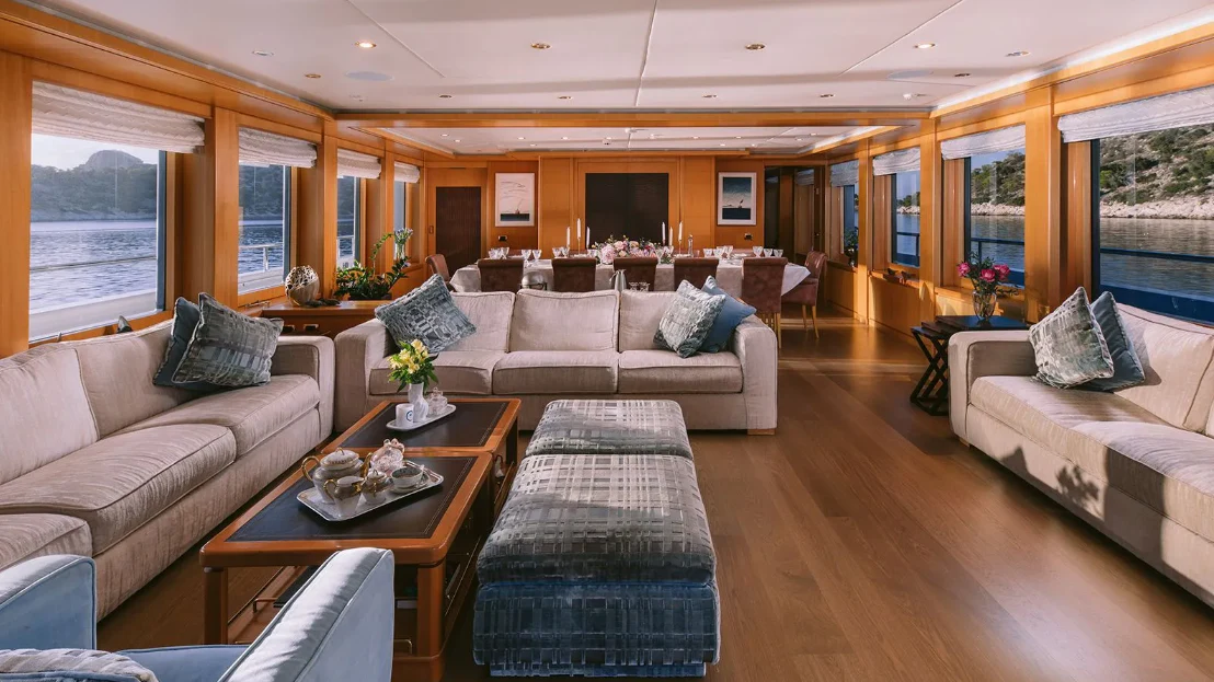 a living room with a couch and a coffee table aboard OASIS Yacht for Sale
