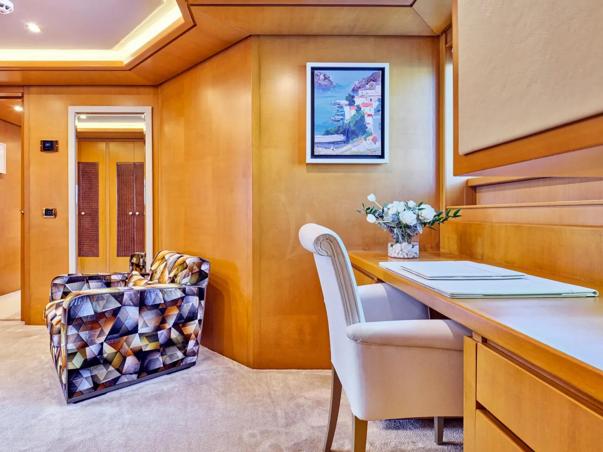 a room with a table and chairs aboard OASIS Yacht for Sale