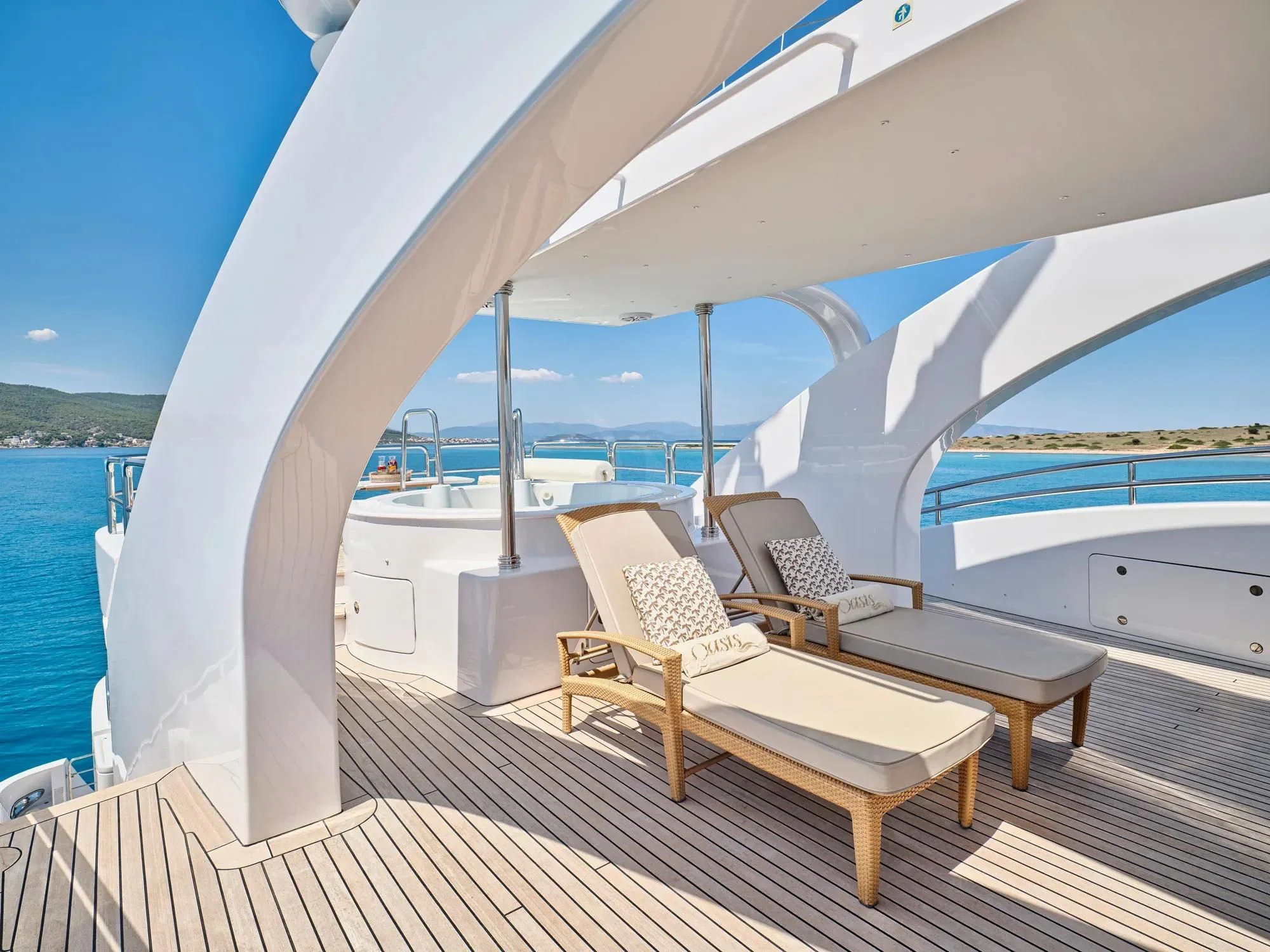 a deck with a view of the ocean and a boat aboard OASIS Yacht for Sale