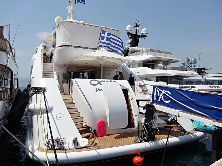 a boat docked at a pier aboard OASIS Yacht for Sale