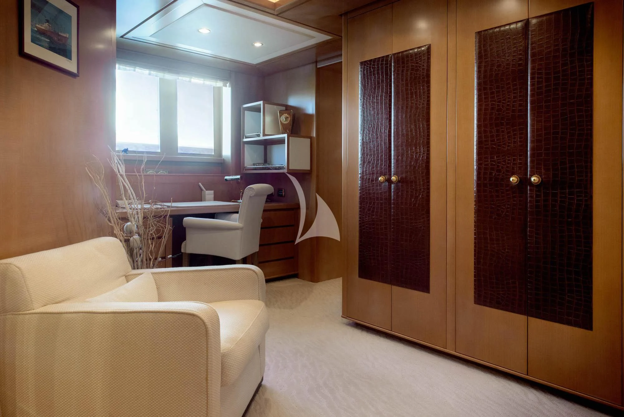a room with a couch and a table and a television aboard OASIS Yacht for Sale