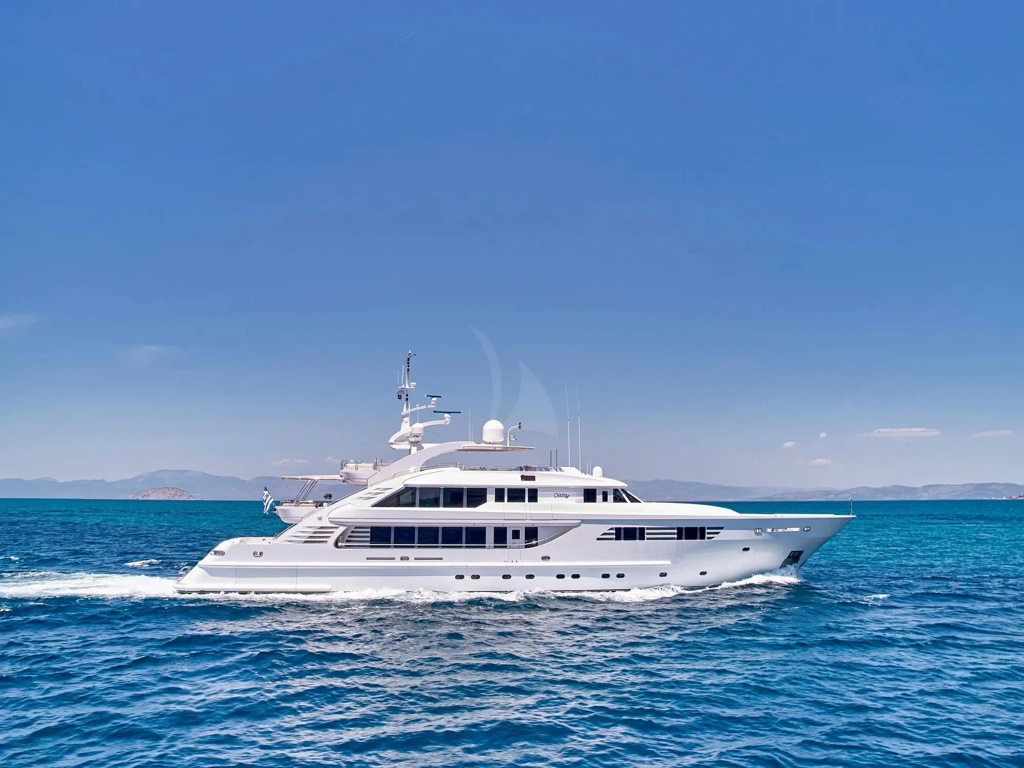 a white boat in the water aboard OASIS Yacht for Sale