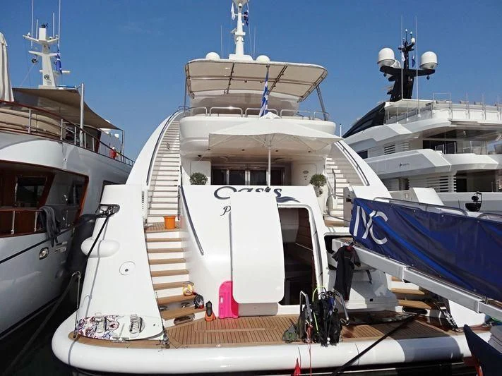 a boat docked at a pier aboard OASIS Yacht for Sale