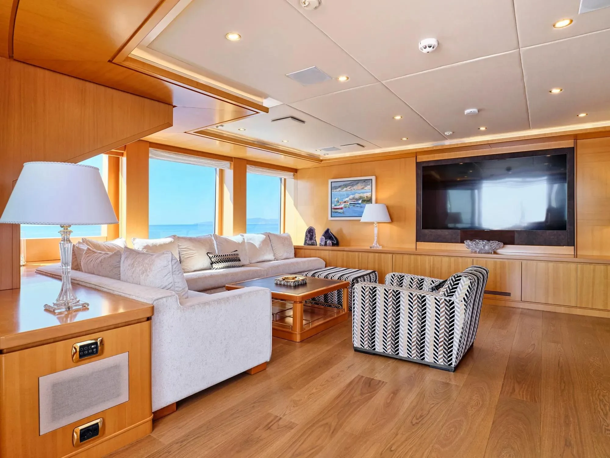a living room with a large screen aboard OASIS Yacht for Sale