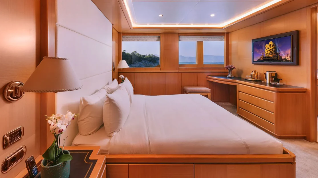 a hotel room with a bed and a tv aboard OASIS Yacht for Sale