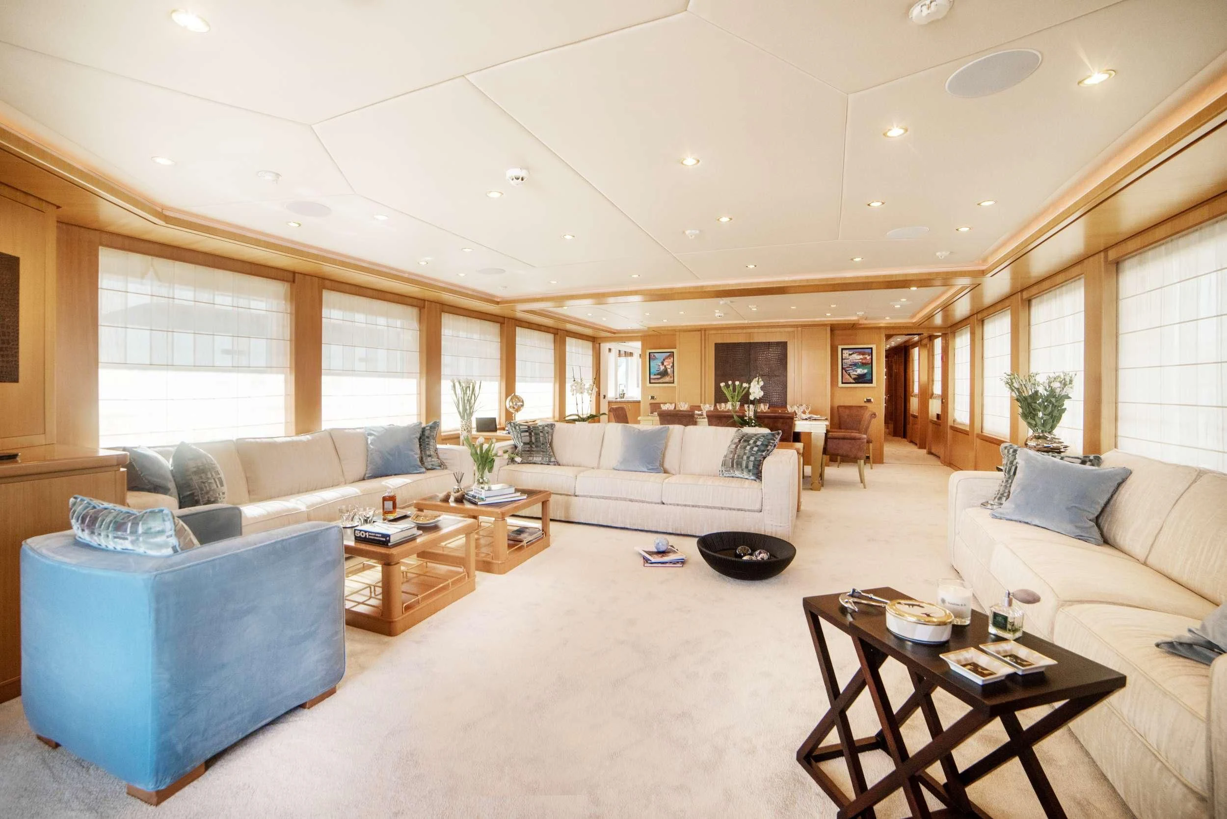 a living room with a couch and a table aboard OASIS Yacht for Sale