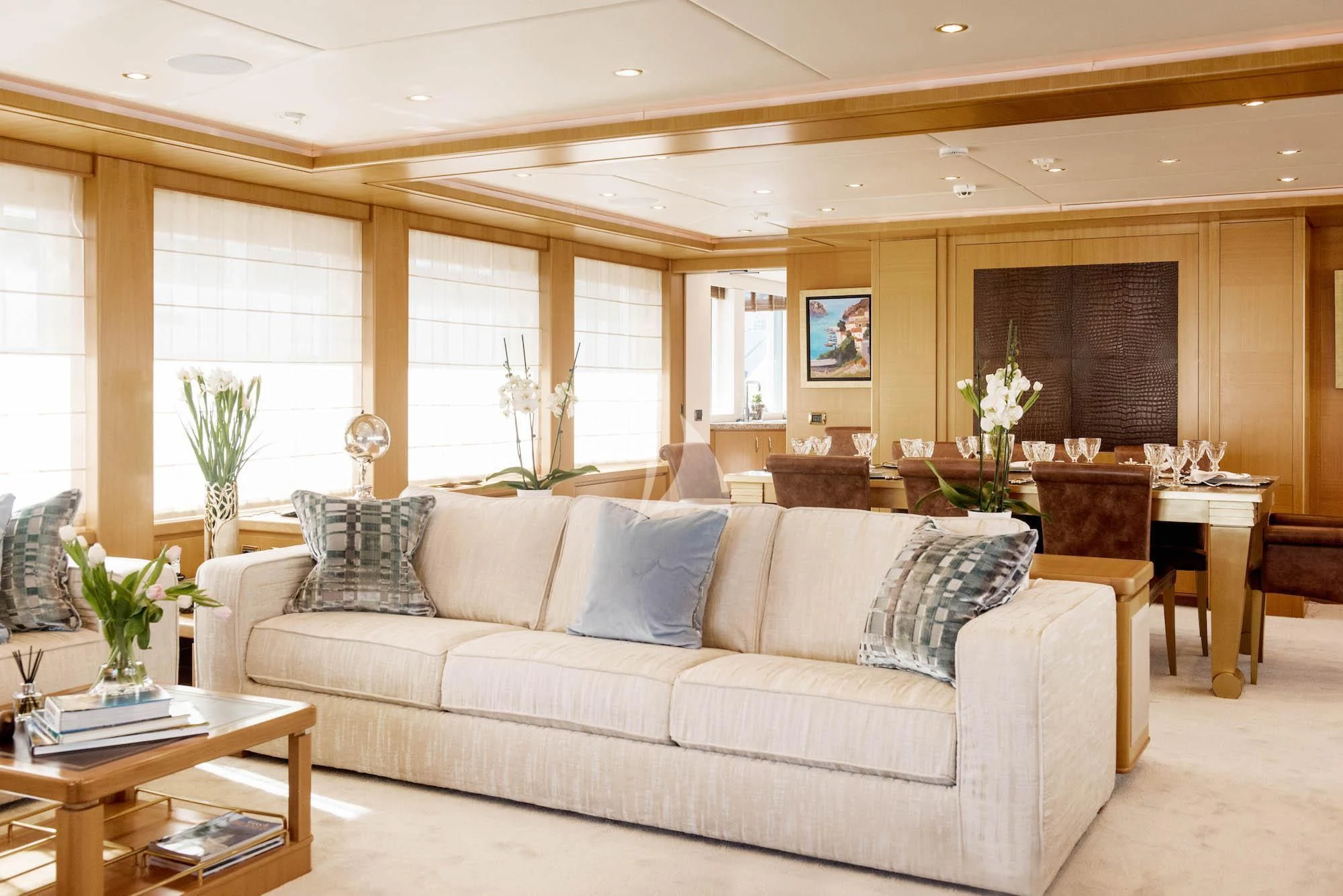 a living room with a couch and a table aboard OASIS Yacht for Sale