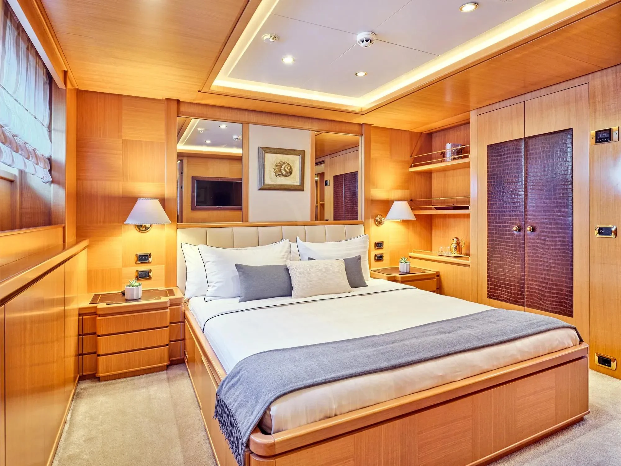a large bedroom with a large bed aboard OASIS Yacht for Sale