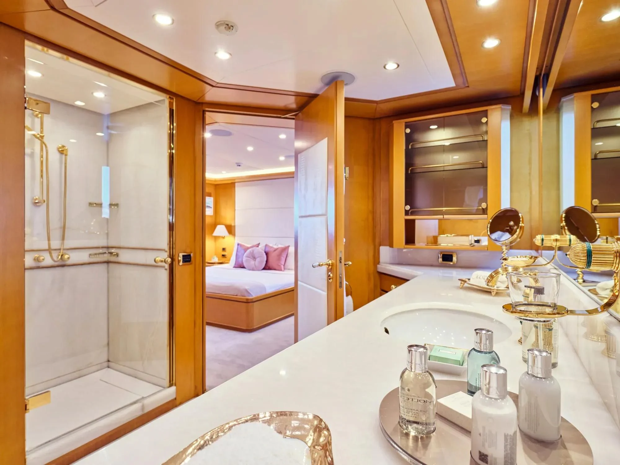 a large bathroom with a large mirror aboard OASIS Yacht for Sale