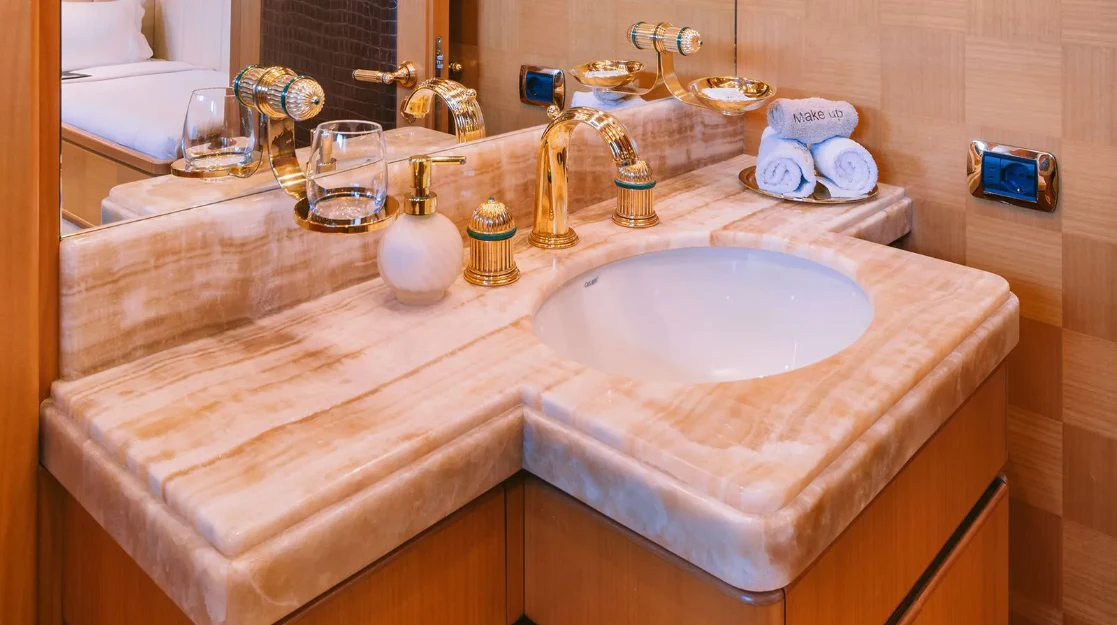 a bathroom sink with a large pink countertop aboard OASIS Yacht for Sale