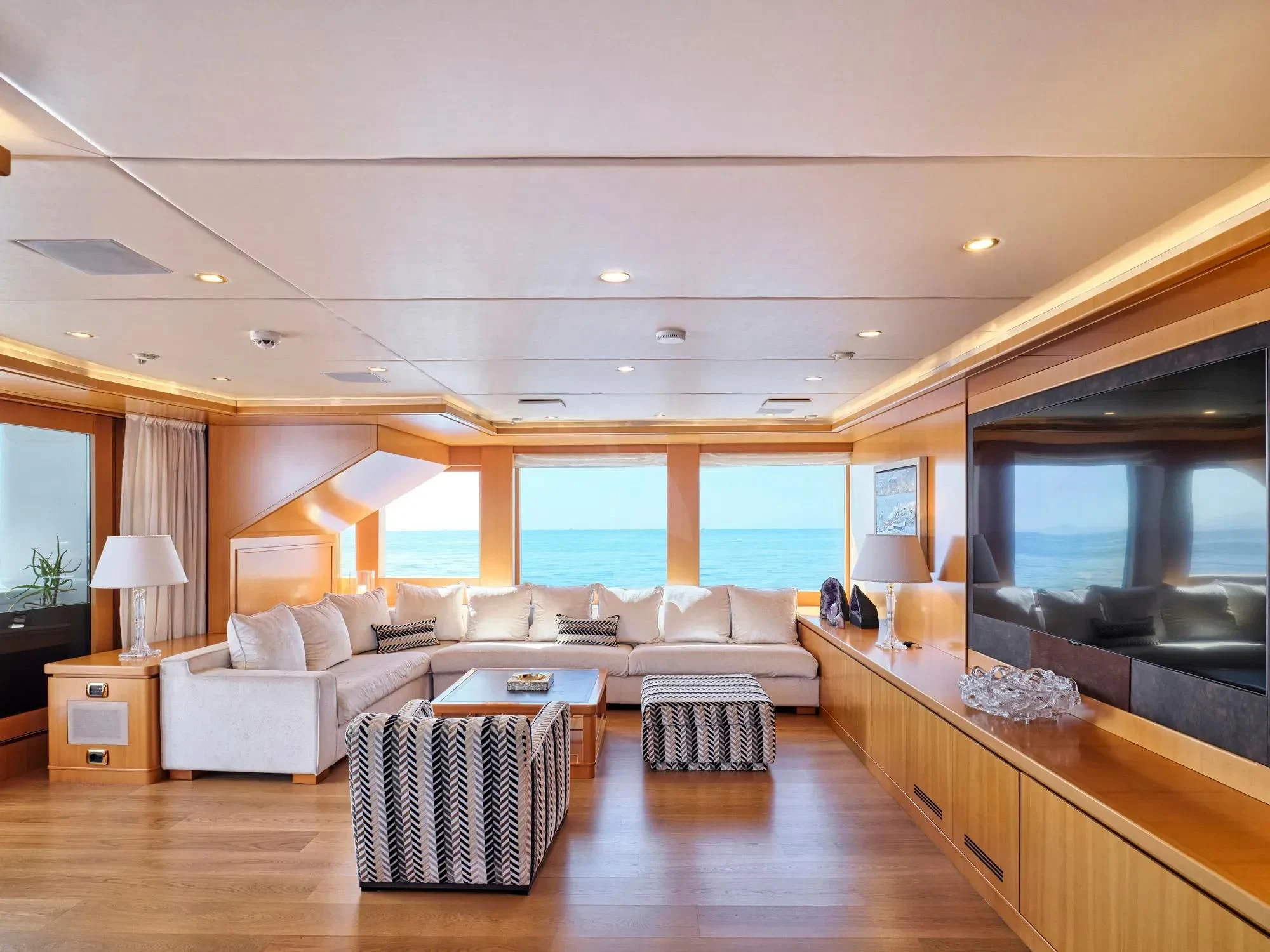 a living room with a large window aboard OASIS Yacht for Sale