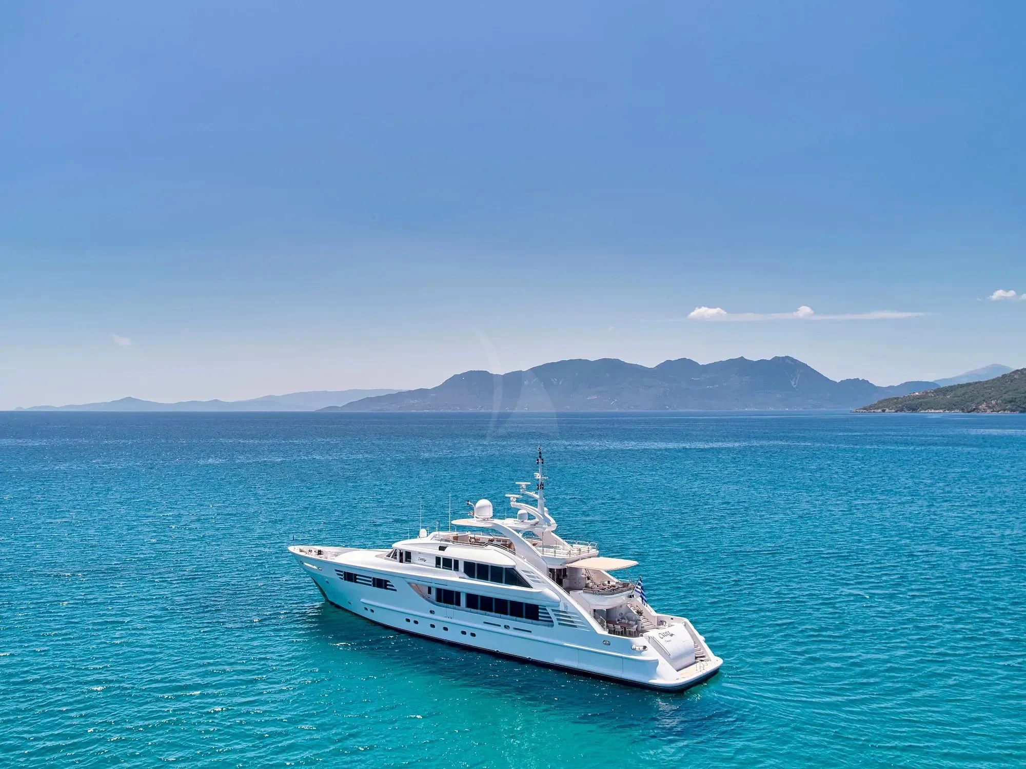 a white boat in the water aboard OASIS Yacht for Sale