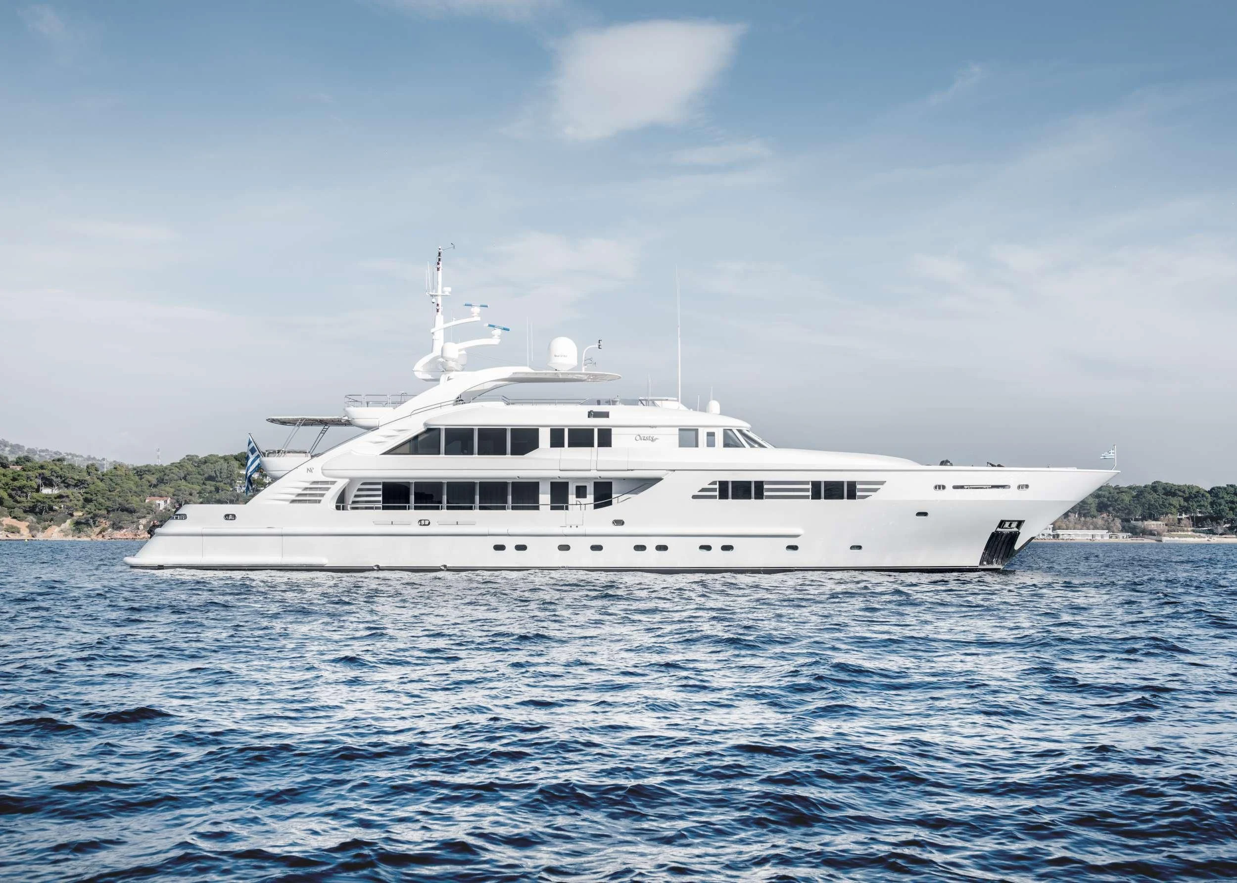 a white boat in the water aboard OASIS Yacht for Sale