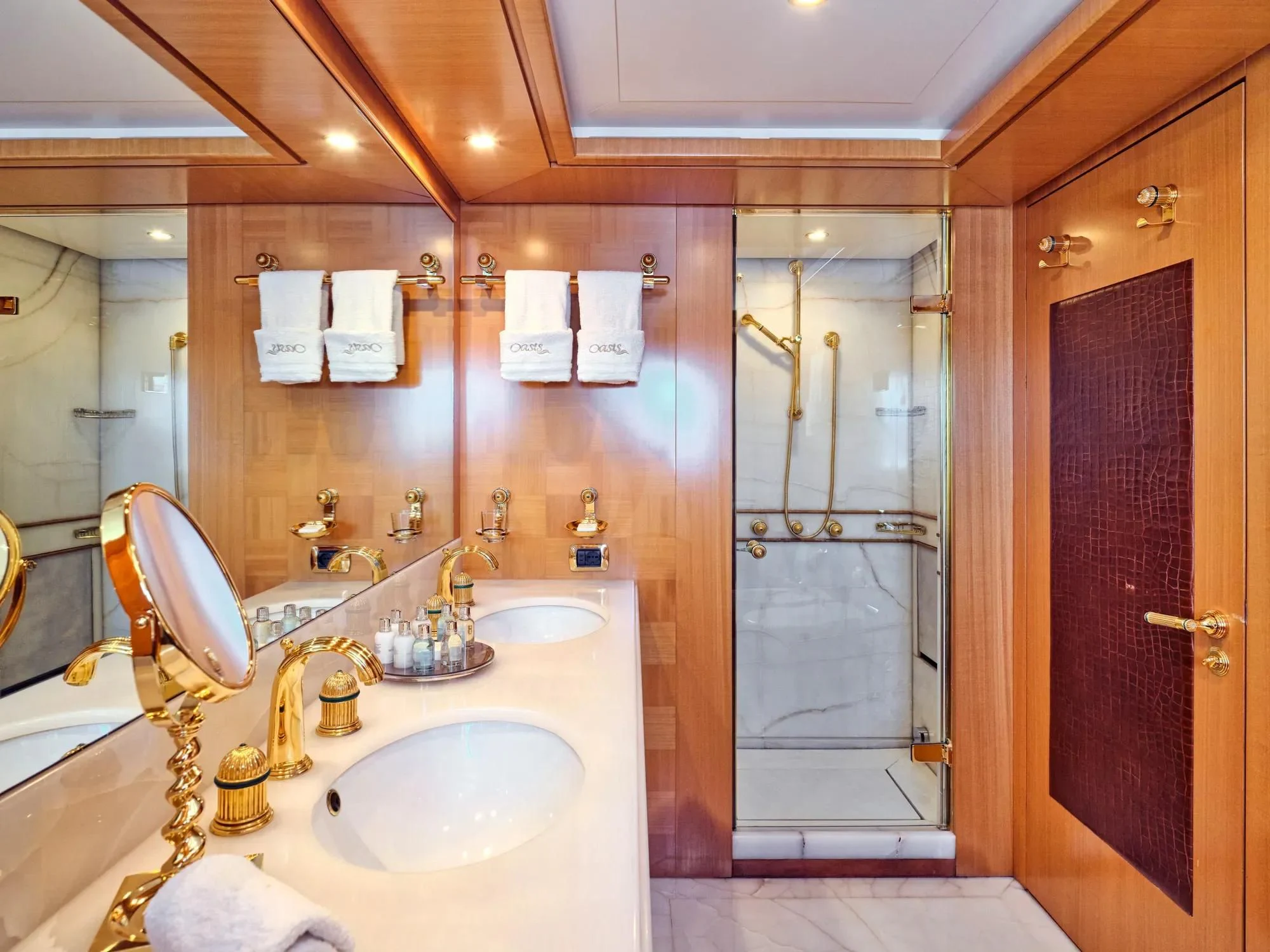 a bathroom with a glass shower aboard OASIS Yacht for Sale