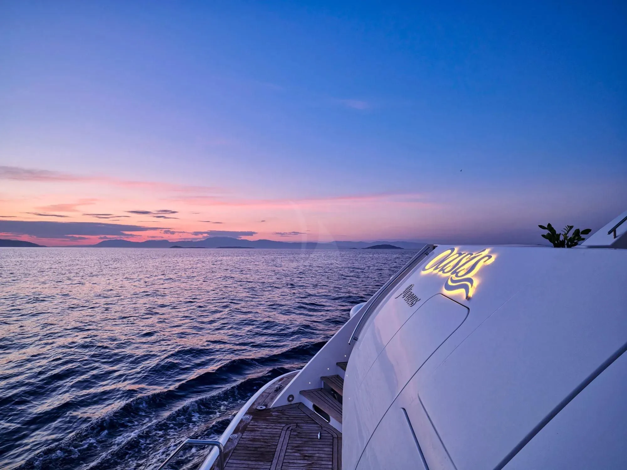 a view of a sunset over water aboard OASIS Yacht for Sale