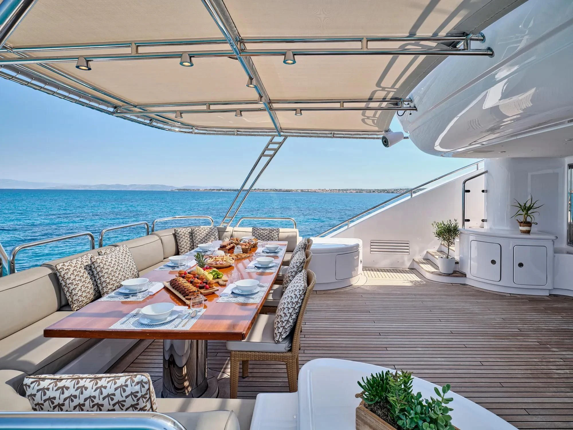 a table set for a meal on a boat aboard OASIS Yacht for Sale