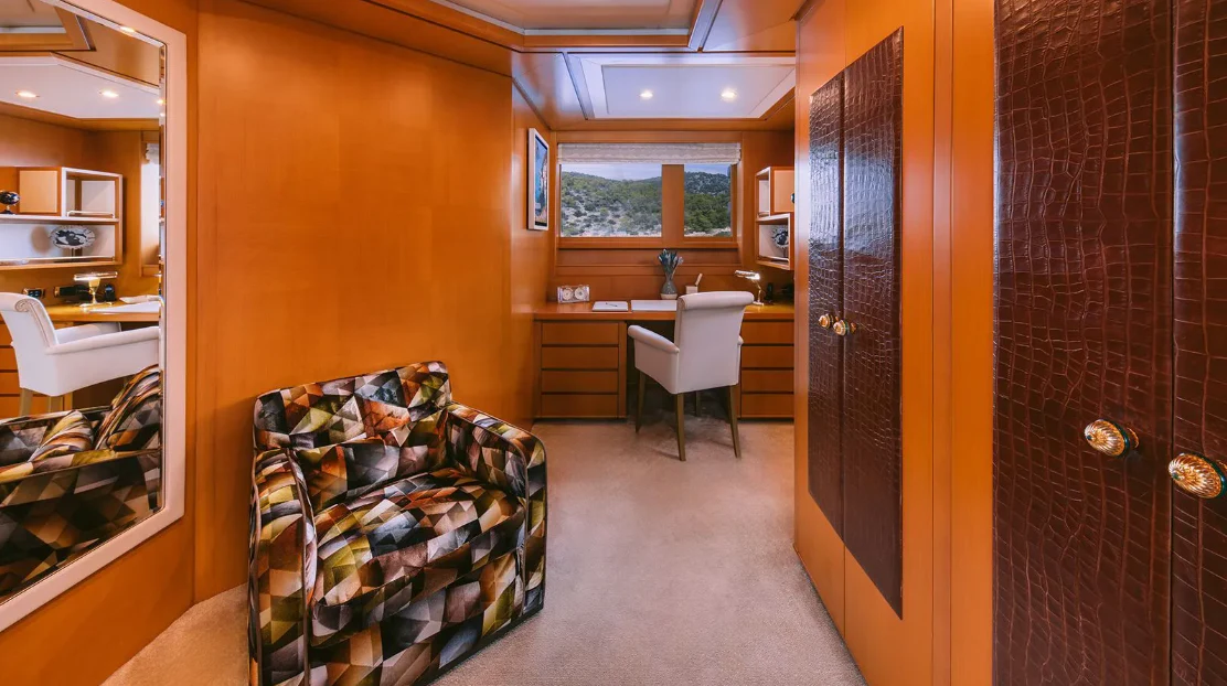 a room with a couch and a table aboard OASIS Yacht for Sale