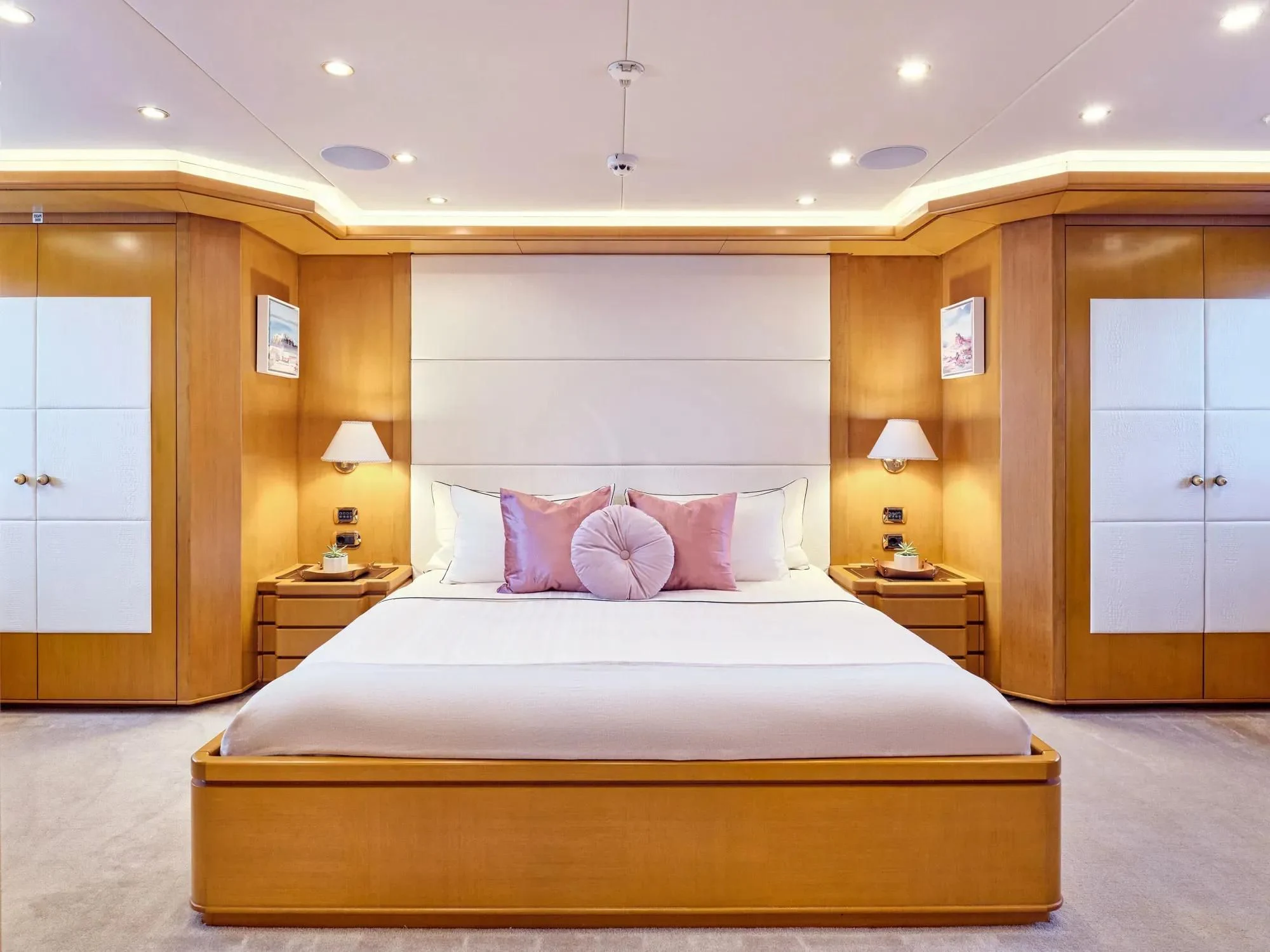 a large bed in a hotel room aboard OASIS Yacht for Sale