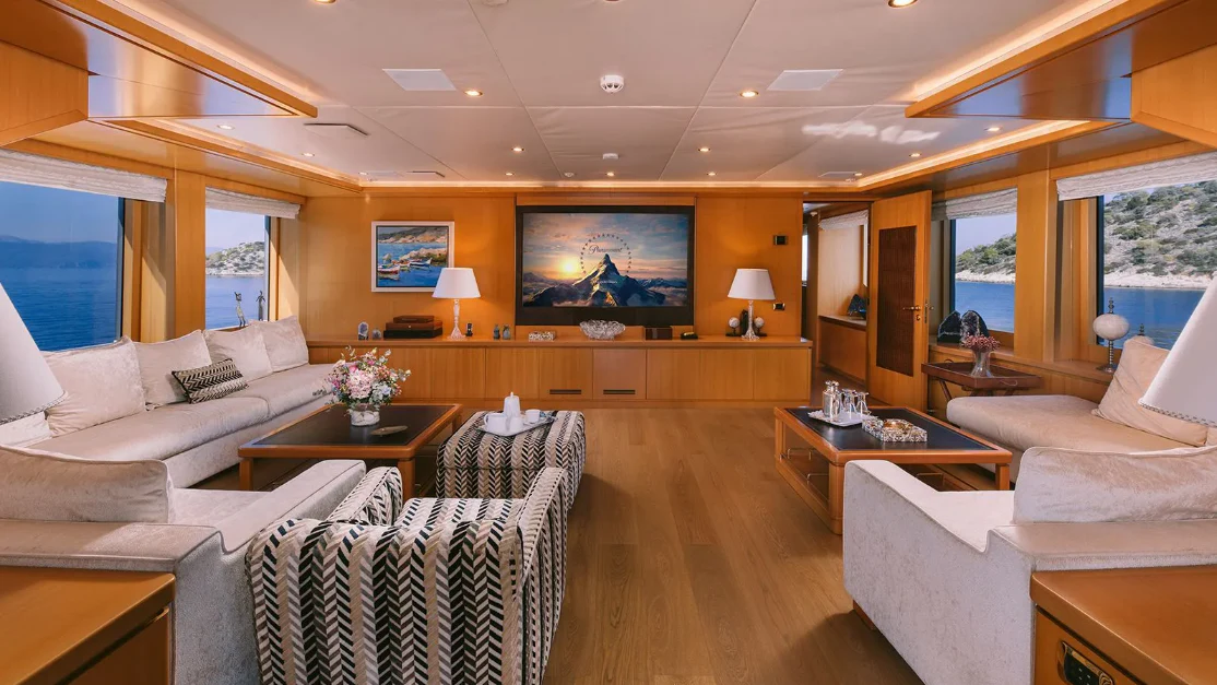 a living room with a large screen aboard OASIS Yacht for Sale