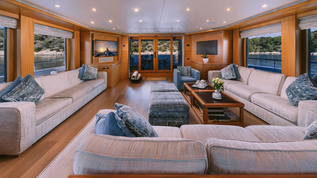 a living room with a couch and a coffee table aboard OASIS Yacht for Sale